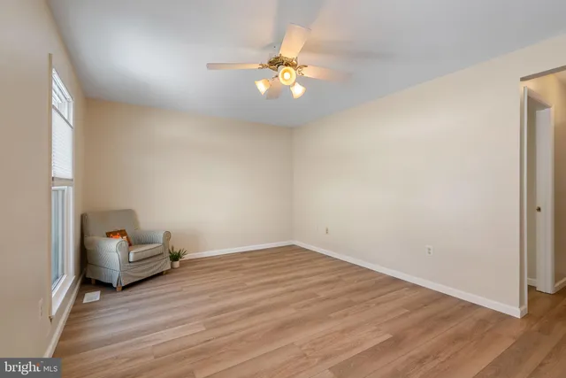 wooden floor in an empty room with a window