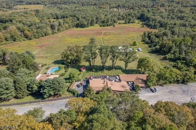 an aerial view of a house with yard swimming pool and outdoor seating