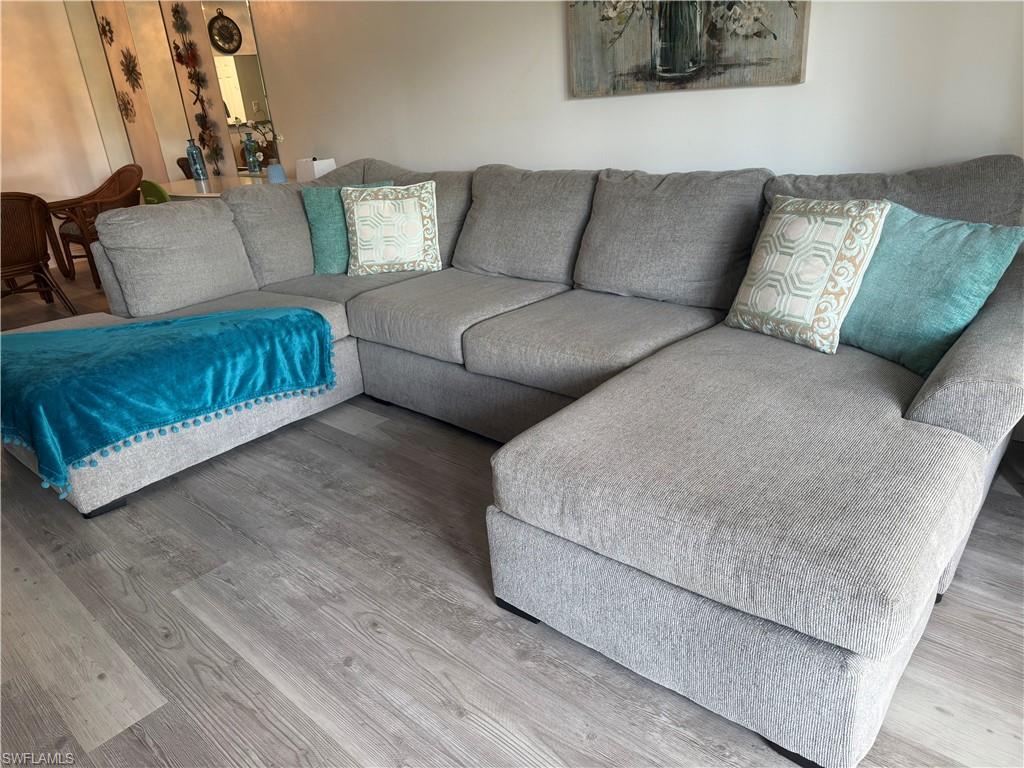 5535 Rattlesnake Hammock Road, Unit 104 Naples, FL 34113 - Photo 12 of 30 a living room with furniture and a couch