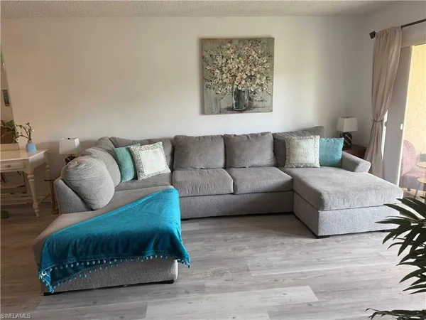 a living room with furniture and a rug