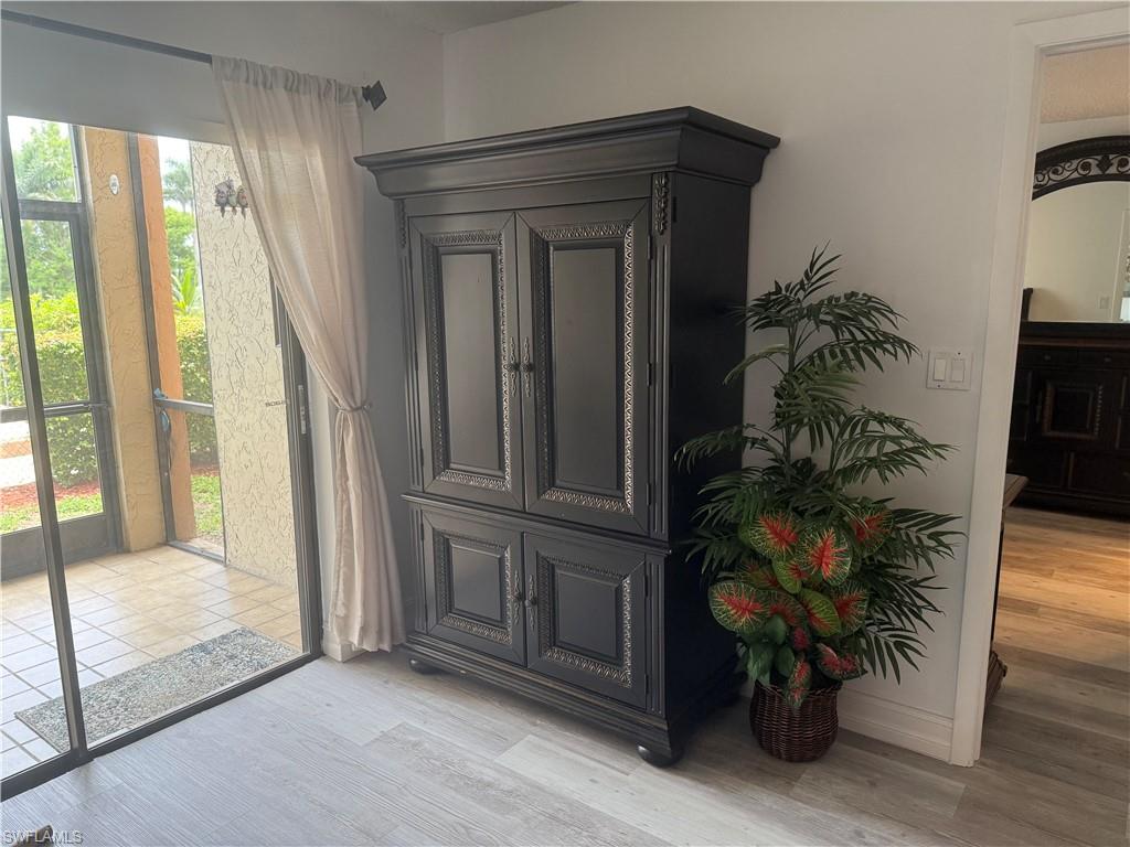 5535 Rattlesnake Hammock Road, Unit 104 Naples, FL 34113 - Photo 14 of 30 a potted plant sitting in front of a window