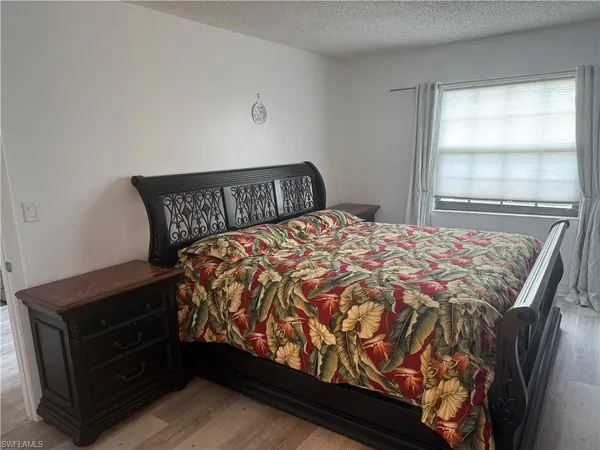 a bed sitting in a bedroom next to a window