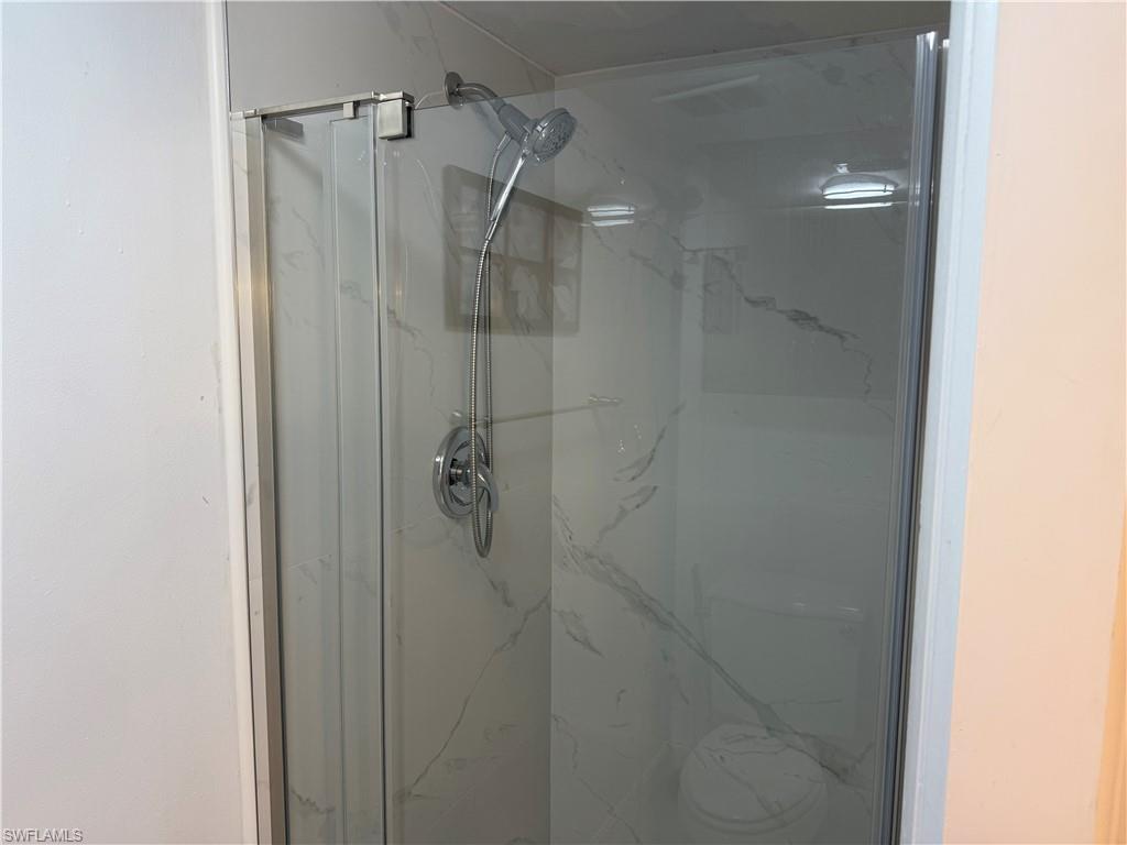 5535 Rattlesnake Hammock Road, Unit 104 Naples, FL 34113 - Photo 22 of 30 a bathroom with a glass shower door