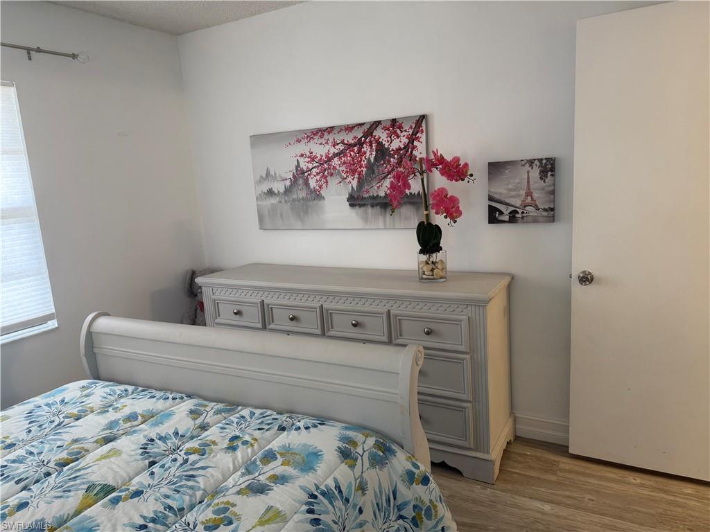 5535 Rattlesnake Hammock Road, Unit 104 Naples, FL 34113 - Photo 24 of 30 a bedroom with a bed and a window