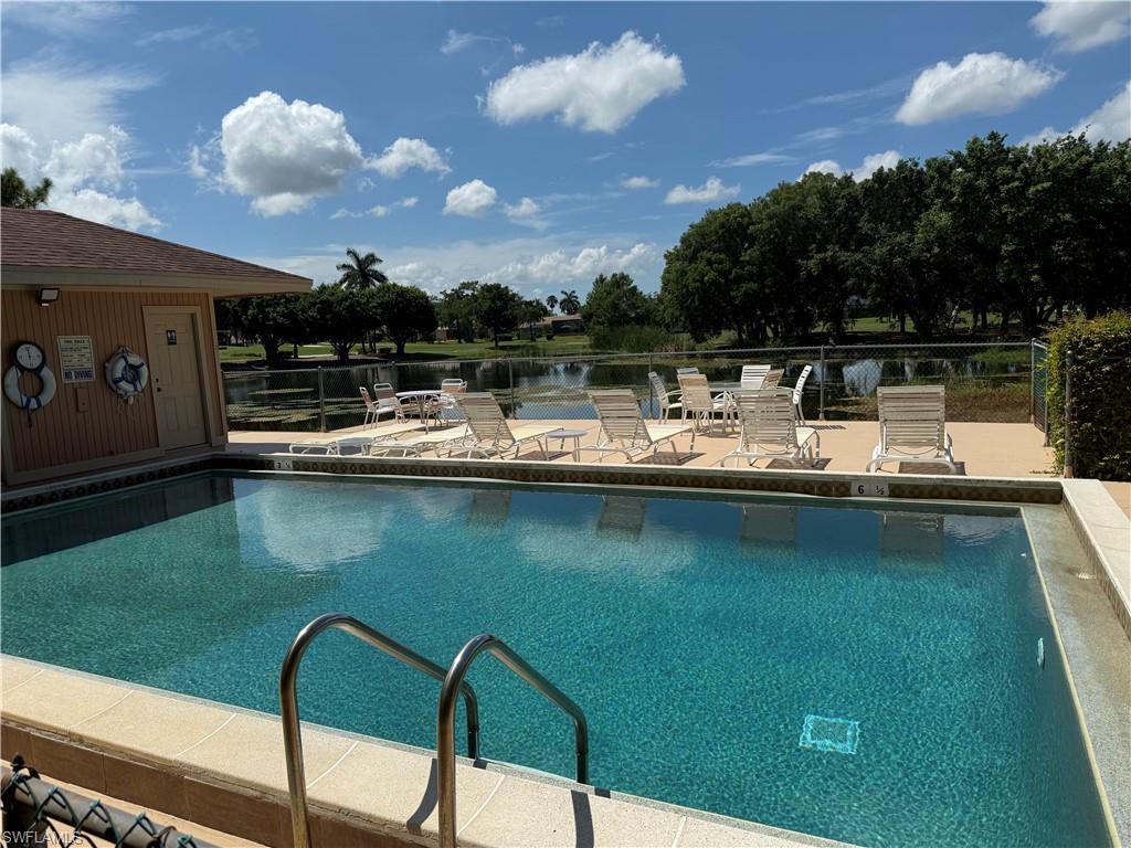 5535 Rattlesnake Hammock Road, Unit 104 Naples, FL 34113 - Photo 30 of 30 a view of a lake with couches chairs