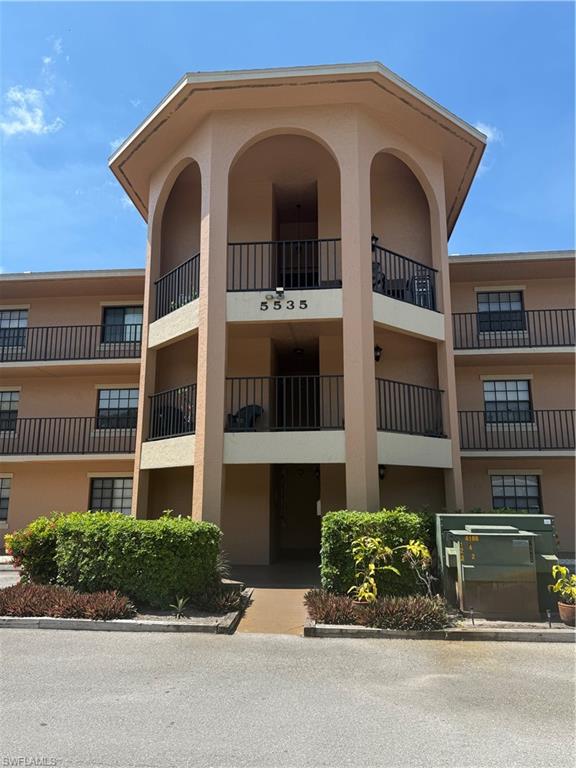 5535 Rattlesnake Hammock Road, Unit 104 Naples, FL 34113 - Photo 4 of 30 a front view of a house