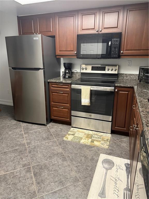 5535 Rattlesnake Hammock Road, Unit 104 Naples, FL 34113 - Photo 6 of 30 a kitchen with a refrigerator and a stove top oven