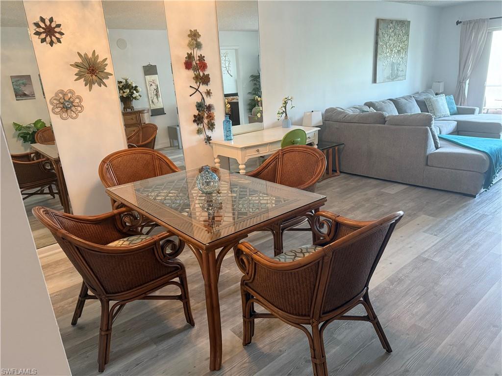 5535 Rattlesnake Hammock Road, Unit 104 Naples, FL 34113 - Photo 10 of 30 a living room with furniture and a potted plant