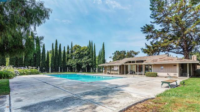 2081 Olivera Road, Unit I Concord, CA 94520 - Photo 22 of 23 a front view of a house with a yard table and chairs