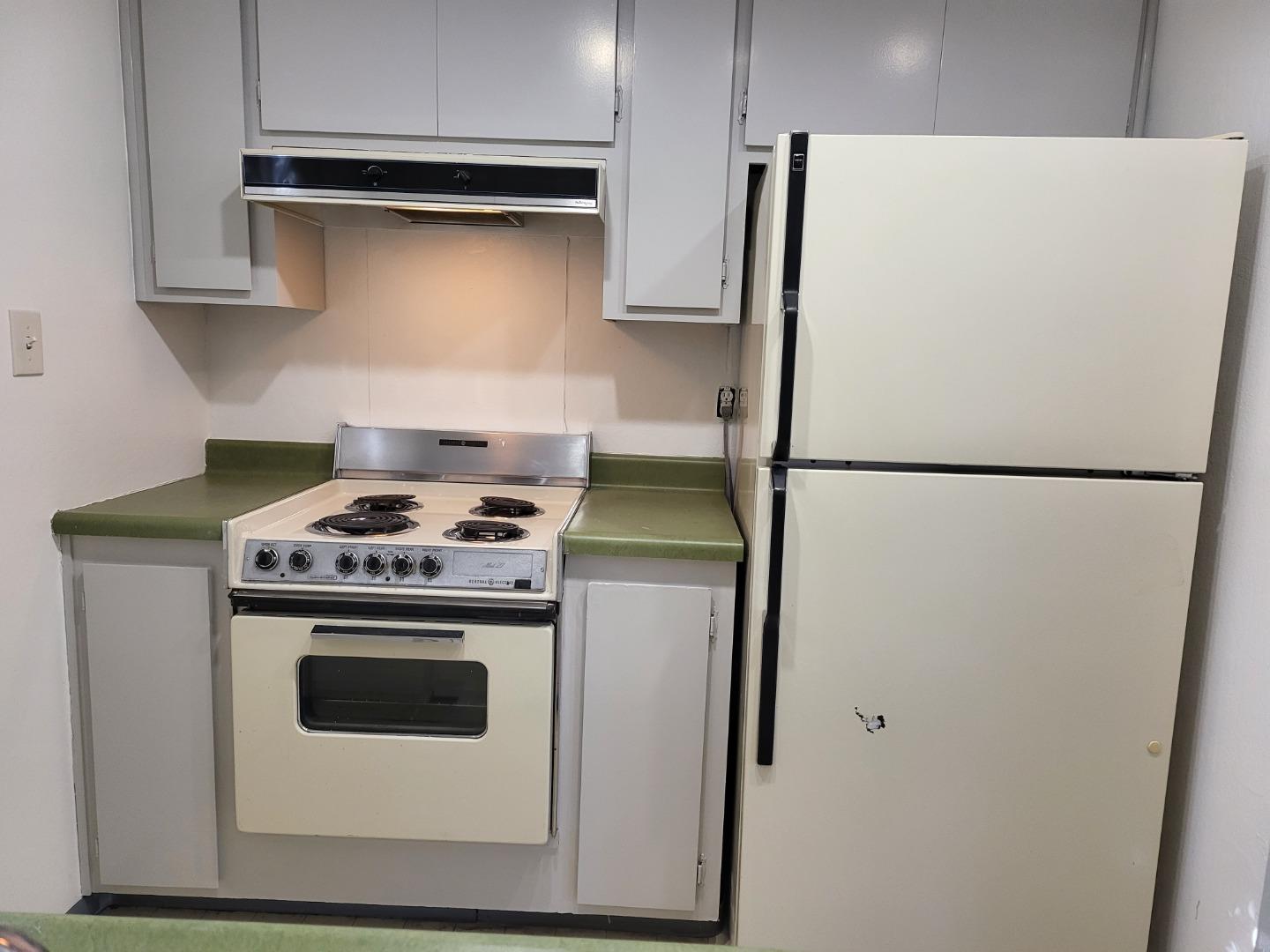 2081 Olivera Road, Unit I Concord, CA 94520 - Photo 6 of 23 a kitchen with a stove and a refrigerator
