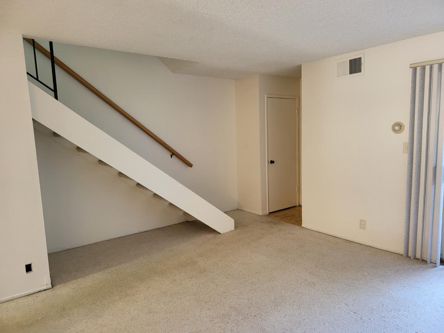 2081 Olivera Road, Unit I Concord, CA 94520 - Photo 8 of 23 a view of an empty room with stairs