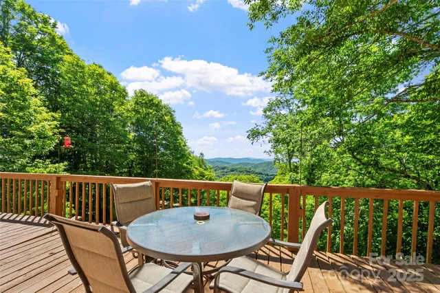 a view of a chairs and tables on the roof deck