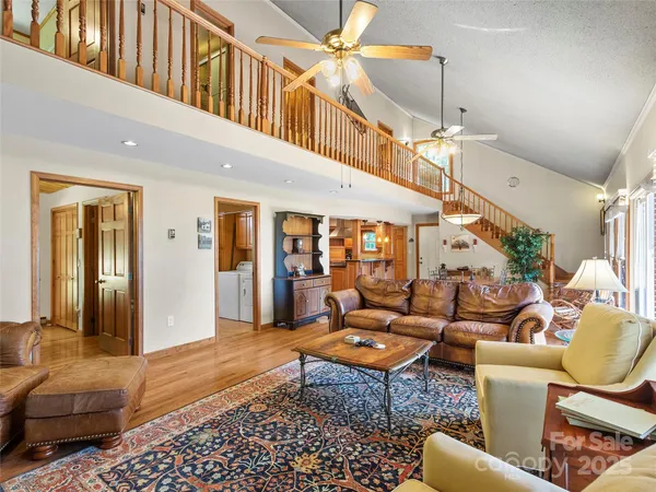 a living room with furniture a rug and a chandelier