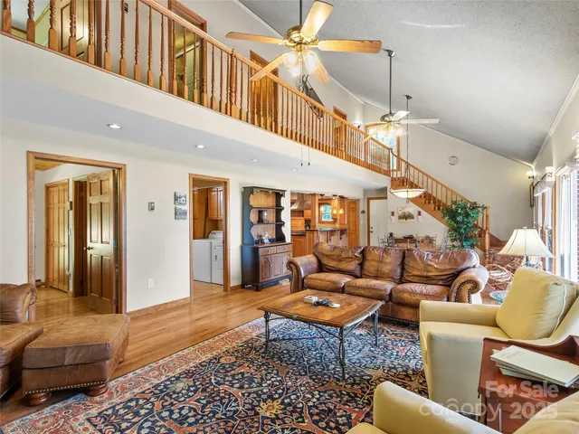 a living room with furniture a rug and a chandelier