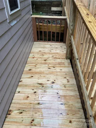 a view of entryway with wooden floor and fence