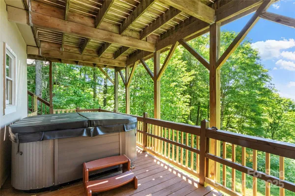 a view of a porch with furniture and a backyard