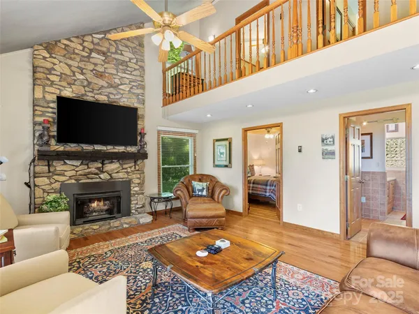 a living room with furniture a flat screen tv and a fireplace