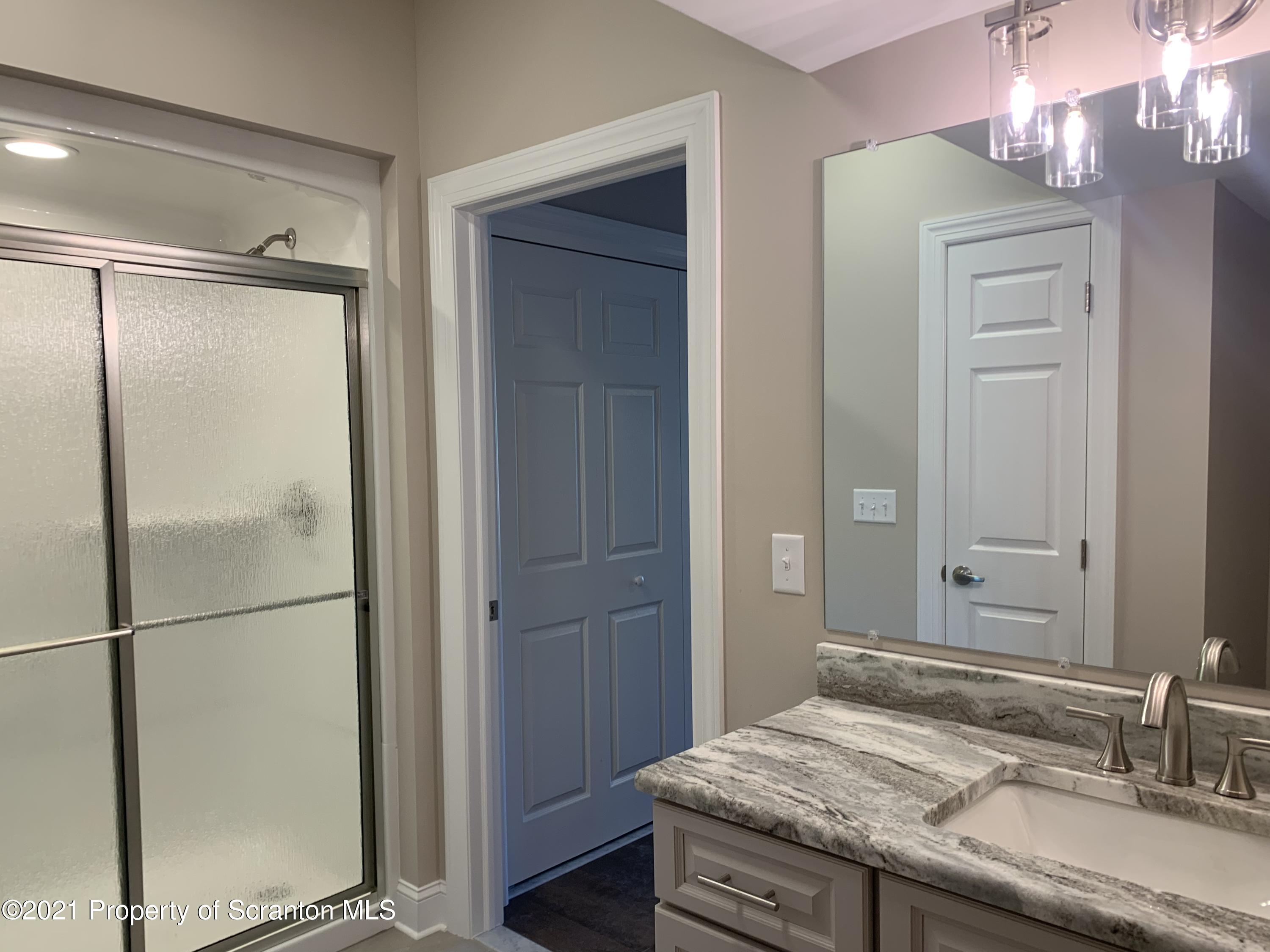 104 Deerfield Drive Eynon, PA 18403 - Photo 16 of 25 a bathroom with a granite countertop sink and a mirror