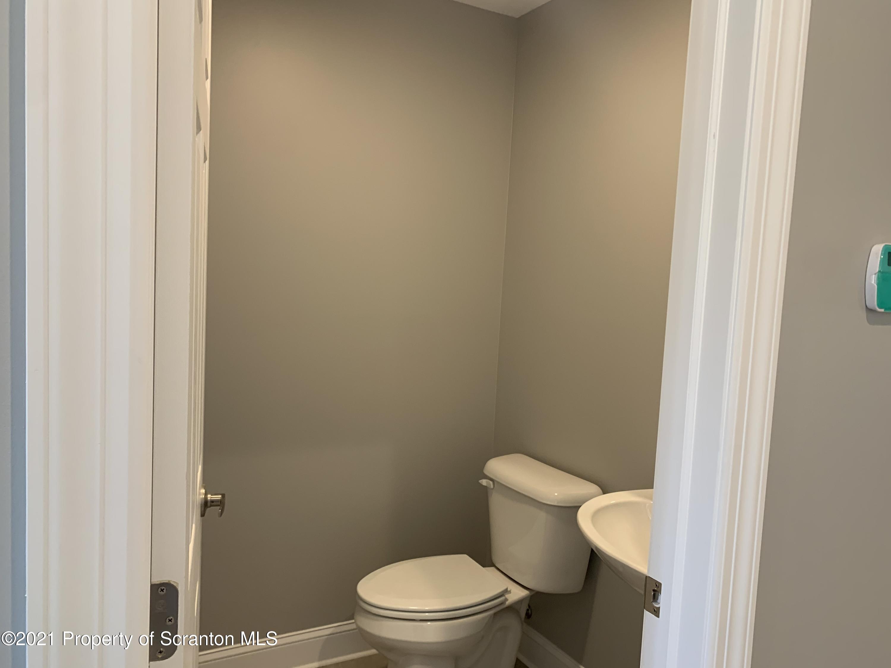 104 Deerfield Drive Eynon, PA 18403 - Photo 18 of 25 a white toilet sitting next to a shower