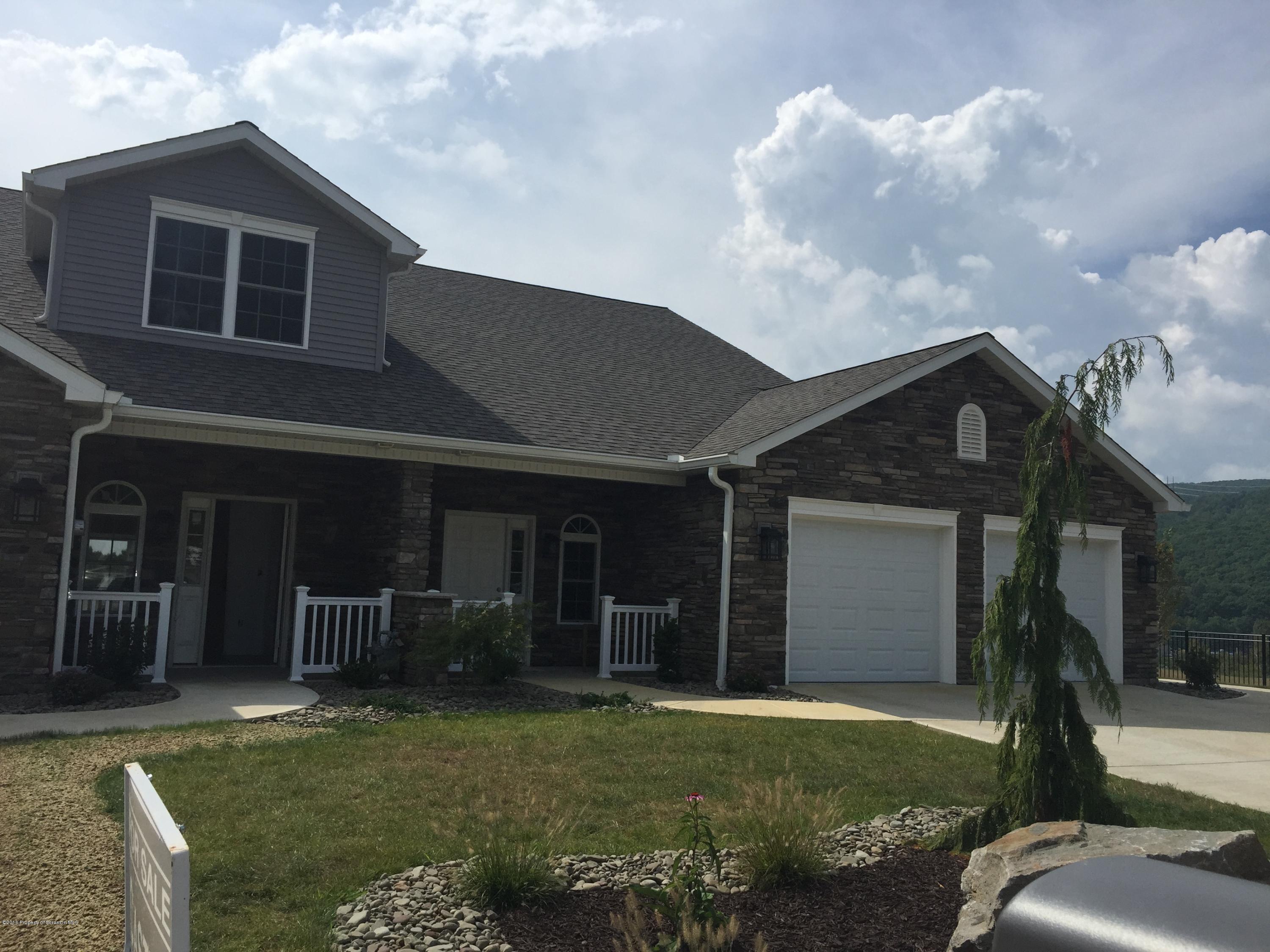 104 Deerfield Drive Eynon, PA 18403 - Photo 2 of 25 a front view of a house with garden