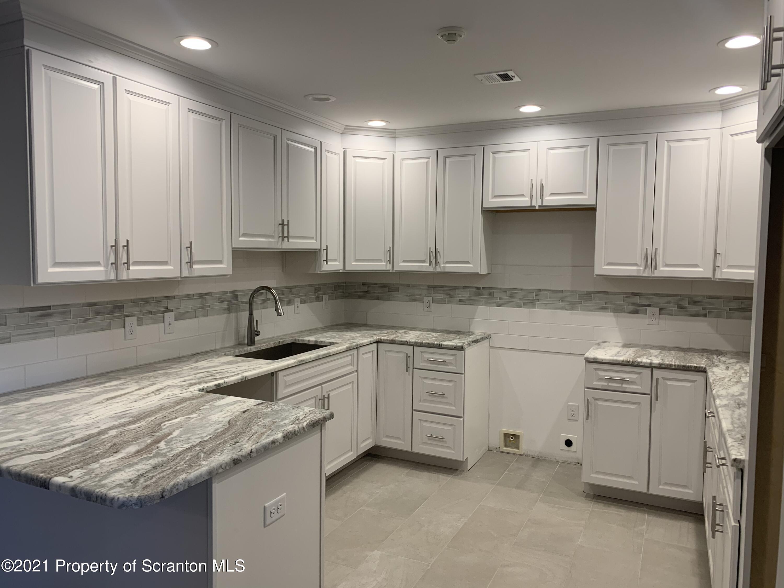 104 Deerfield Drive Eynon, PA 18403 - Photo 5 of 25 a kitchen with granite countertop cabinets stainless steel appliances and a sink