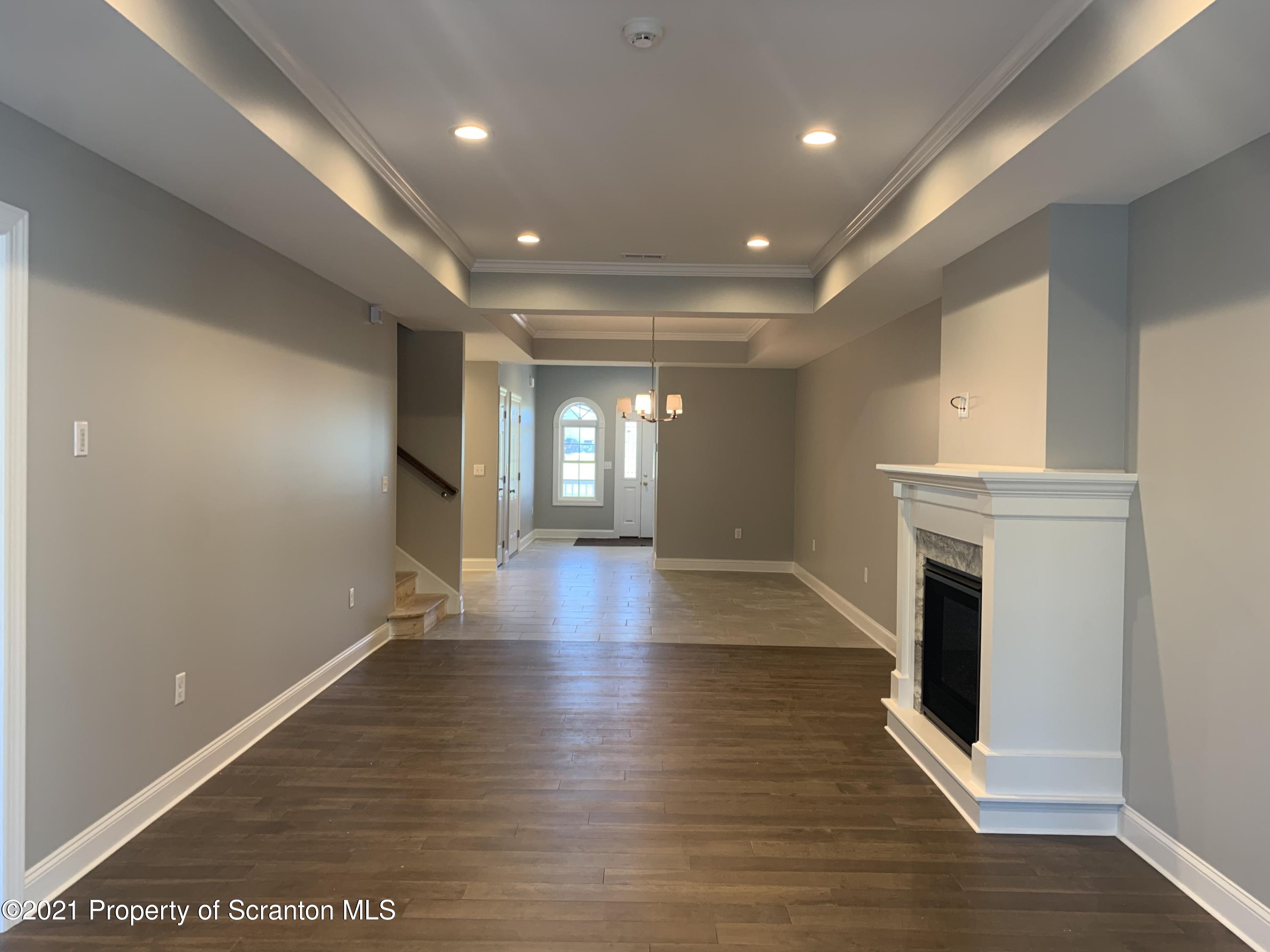 104 Deerfield Drive Eynon, PA 18403 - Photo 7 of 25 a view of a room with wooden floor and fireplace