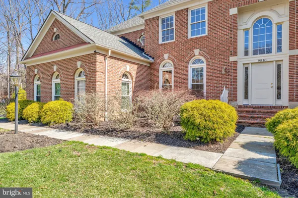 a view of a brick house with a yard