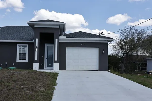a front view of a house with a yard