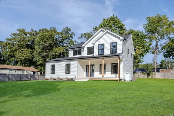 a front view of a house with a garden and porch
