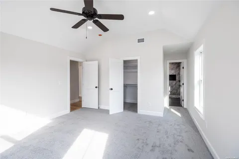 a view of empty room with ceiling fan