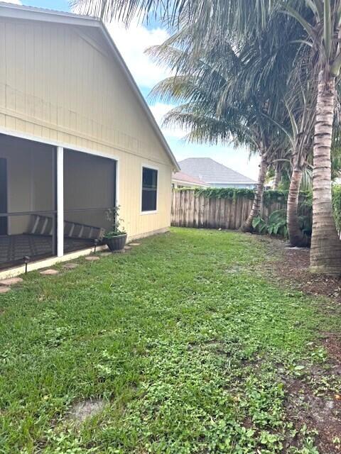 6362 Barbara Street Jupiter, FL 33458 - Photo 19 of 20 a view of a house with a yard and garage