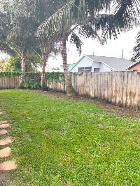 6362 Barbara Street Jupiter, FL 33458 - Photo 20 of 20 a view of a yard with a trees