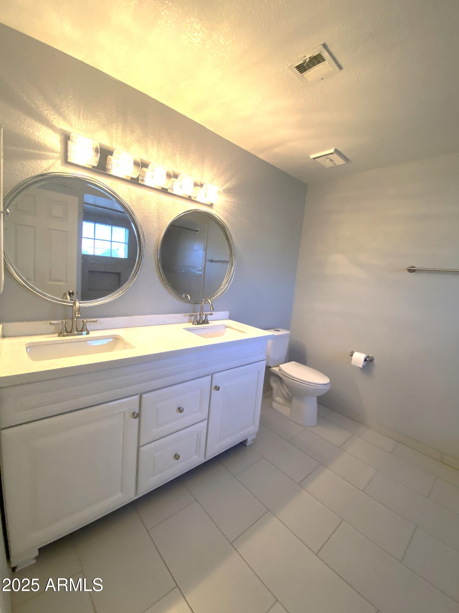 101 North 7th Street, Unit 270 Phoenix, AZ 85034 - Photo 15 of 23 a bathroom with a double vanity sink and a mirror