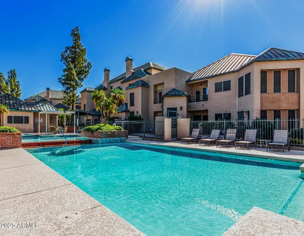 a front view of a house with swimming pool having outdoor seating