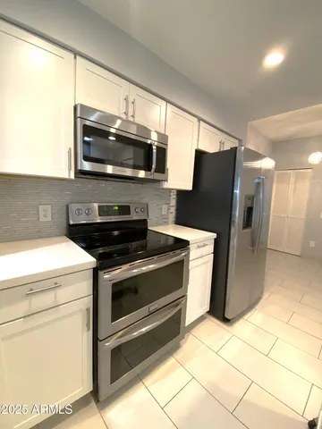 a kitchen with a stove a microwave and refrigerator