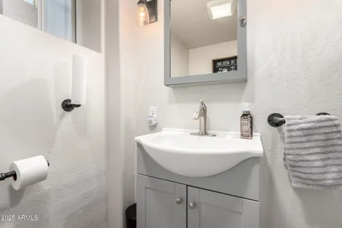 a bathroom with a sink a mirror and shower