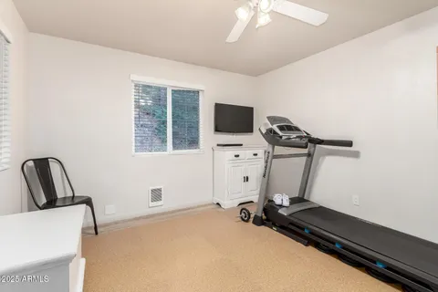 a room with gym equipment and a flat screen tv