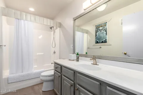 a bedroom with furniture and a large window