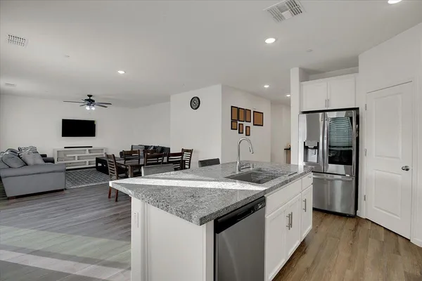 a kitchen with stainless steel appliances granite countertop a sink and refrigerator