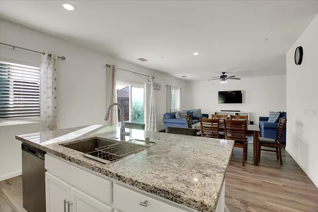 a kitchen with sink refrigerator and table