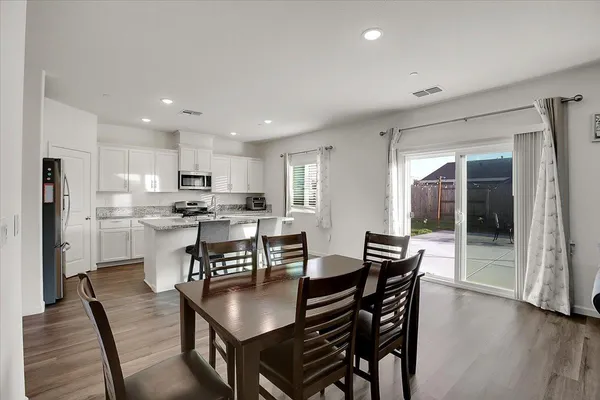 a view of a dining room with furniture and wooden floor