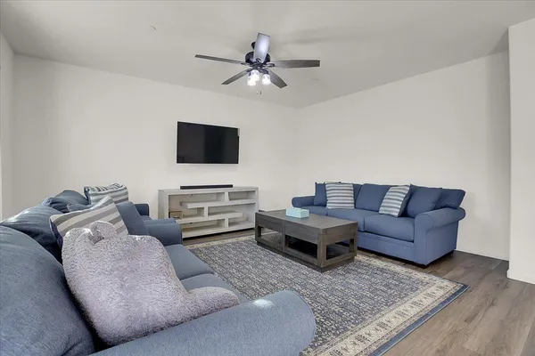 a living room with furniture and a flat screen tv