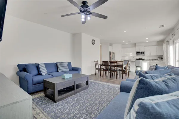a living room with furniture and kitchen view
