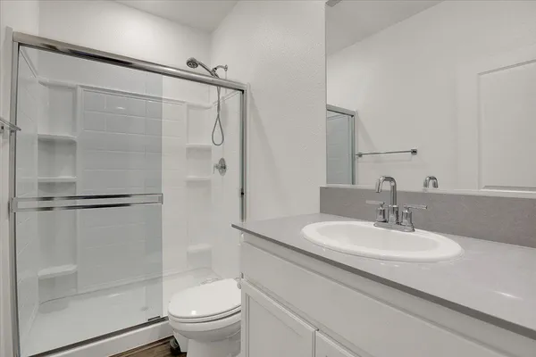a bathroom with a sink toilet and shower