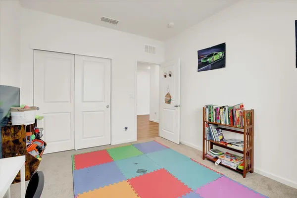 a bedroom with furniture and a book shelf