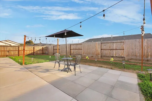 a view of a chairs and tables in the back yard