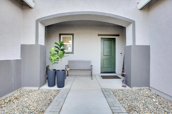 a view of a hallway with potted plants