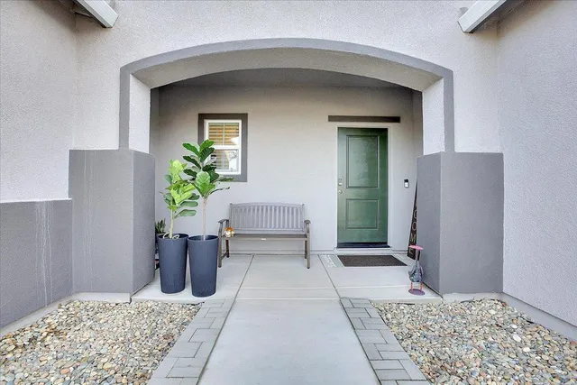 a view of a hallway with potted plants