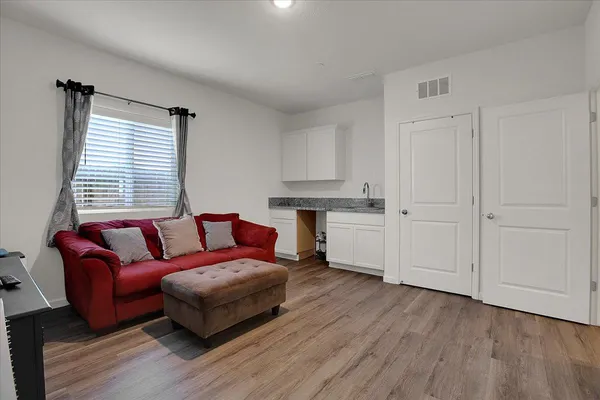 a living room with furniture and wooden floor