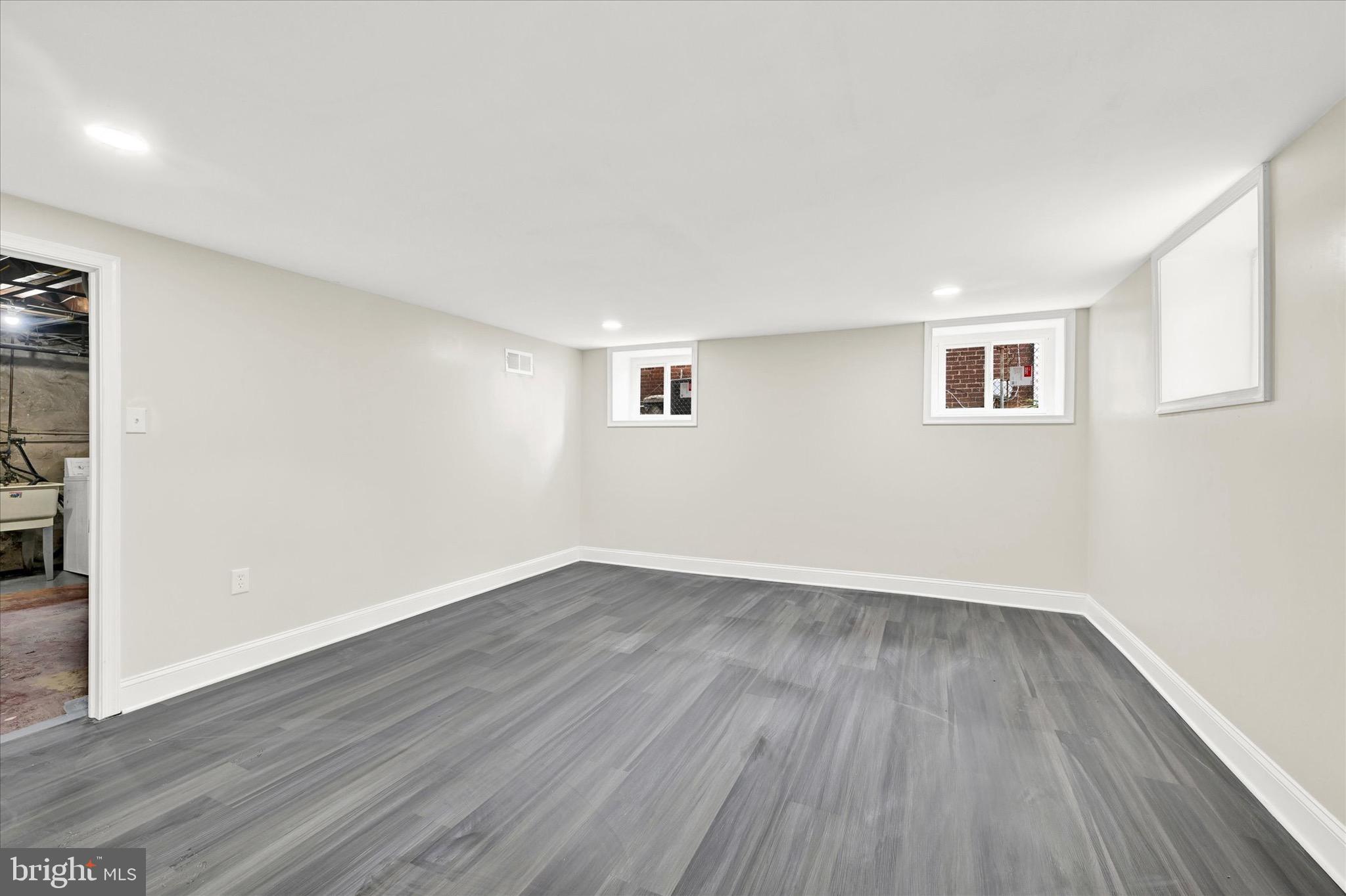 3940 Penhurst Avenue Baltimore, MD 21215 - Photo 18 of 24 a view of an empty room with wooden floor